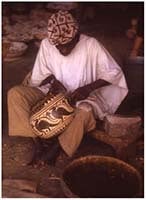 man decorating a calabash