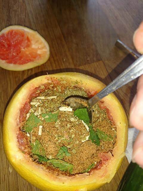 mixing everything inside the grapefruit