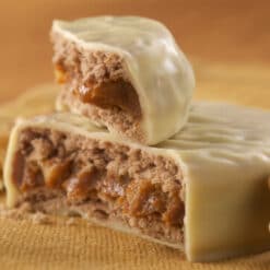 alfajor with white chocolate cover and dulce de leche and walnut filling