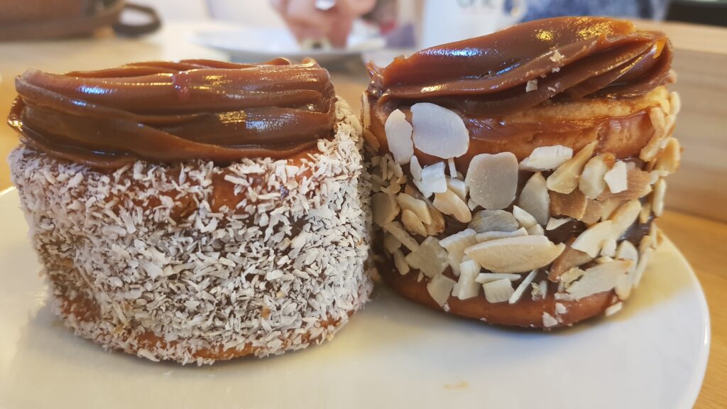 artisan alfajors with dulce de leche filling and topping, coconut and flaked almonds