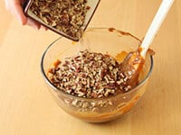 adding chopped nuts to the dulce de leche